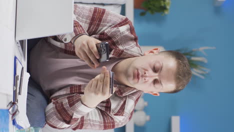 vertical video of home office worker man shopping on the phone.