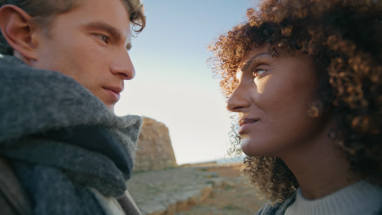 Joyful couple embrace together by sunset sky closeup. Love sweethearts cuddle