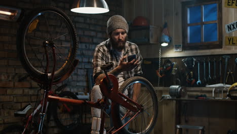 man in garage confused about bicycle repair