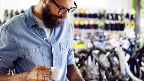 mechanic using mobile phone in workshop