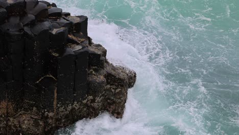 dynamic ocean waves hitting a rugged coastal barrier