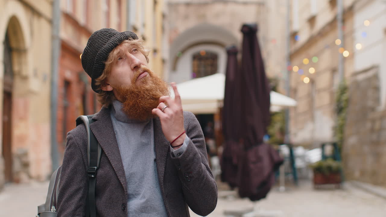 Thoughtful young man with pensive expression pondering a solution thinking inspiration dreaming