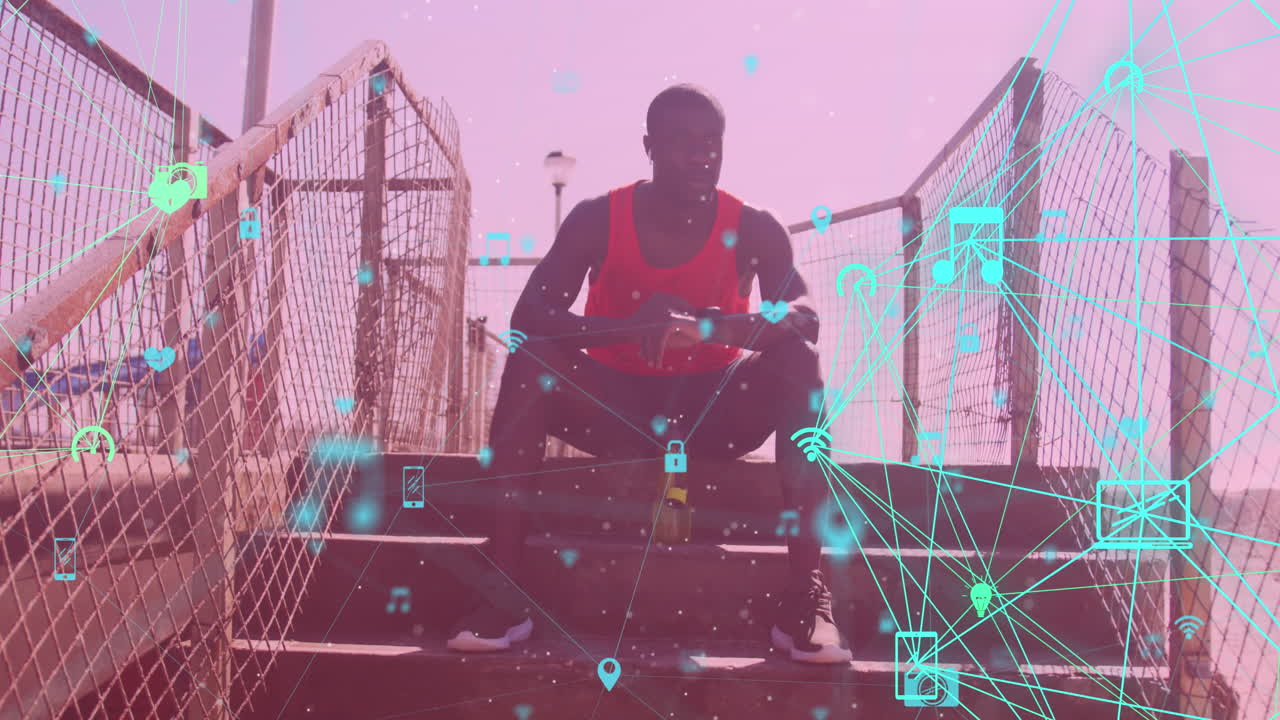 Globes of digital icons against african american fit man using smartwatch sitting on the stairs