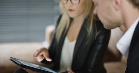 extreme close up of business woman using tablet computer on a meeting 2