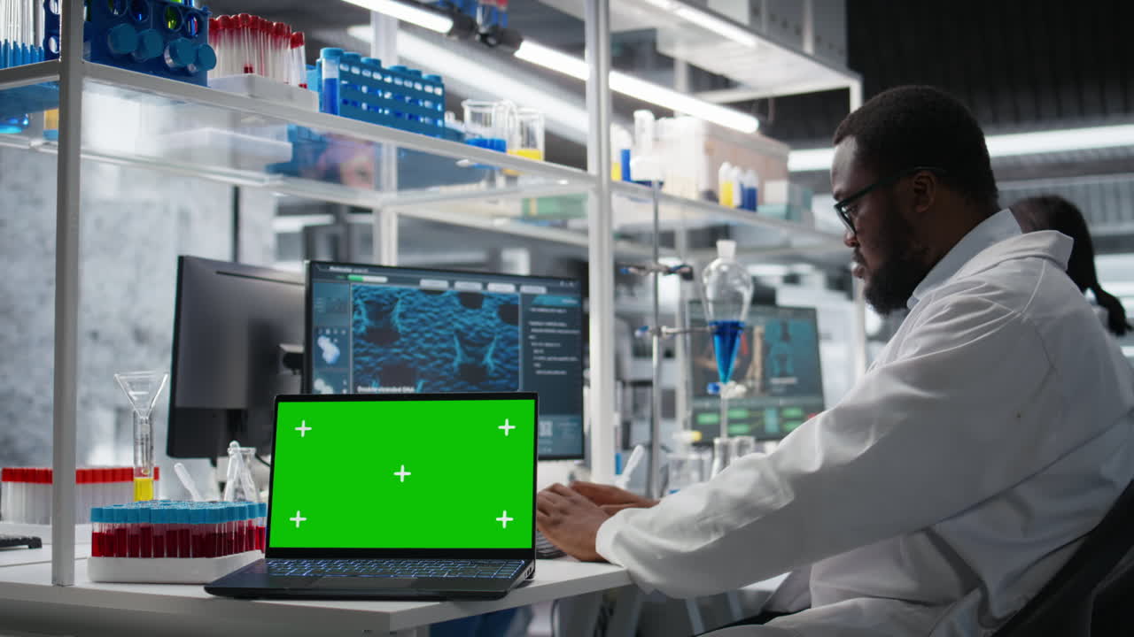 Vertical video Cytotechnologist works on green screen laptop in lab