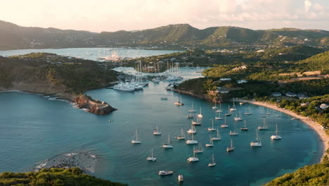 aerial shot of sunset in english harbor in antigua, caribbean with views of yachts, sailboats, marina, bay and cliffs