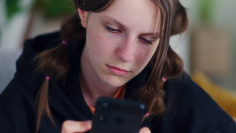 teenage girl browses the internet on a smartphone