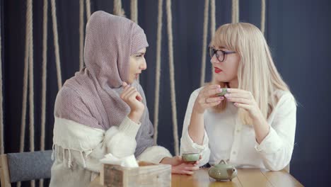 two women chatting over tea