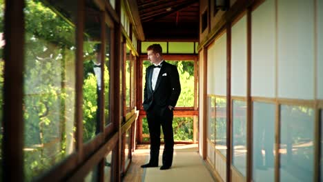 groom in a tuxedo in a japanese garden