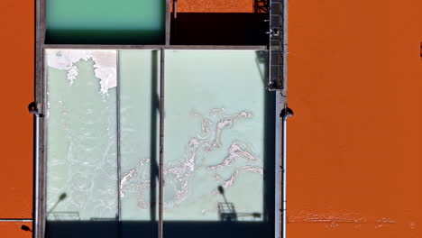 tracking shot over wastewater treatment system with angular layout and color changes