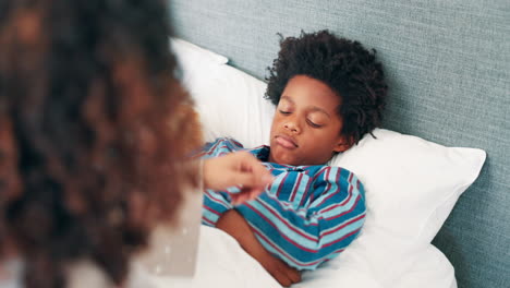 mother checking child's temperature