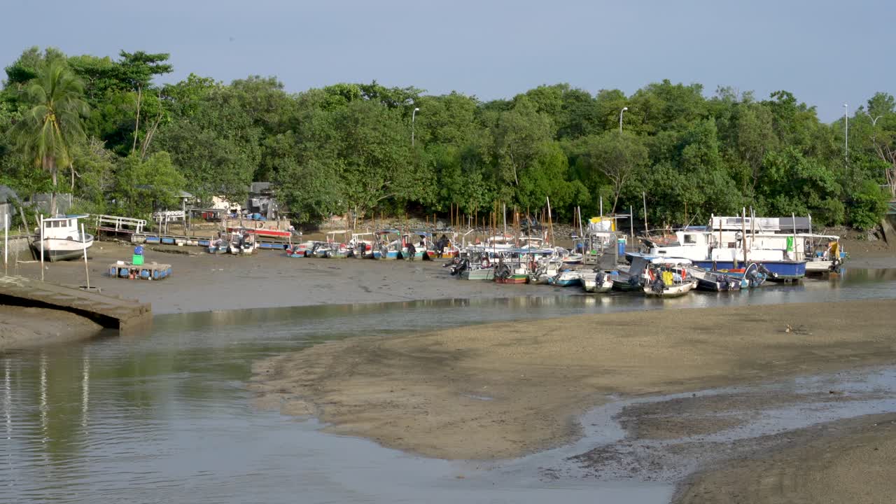 Boats moored at pier mooring low tide, Changi Beach, SIngapore