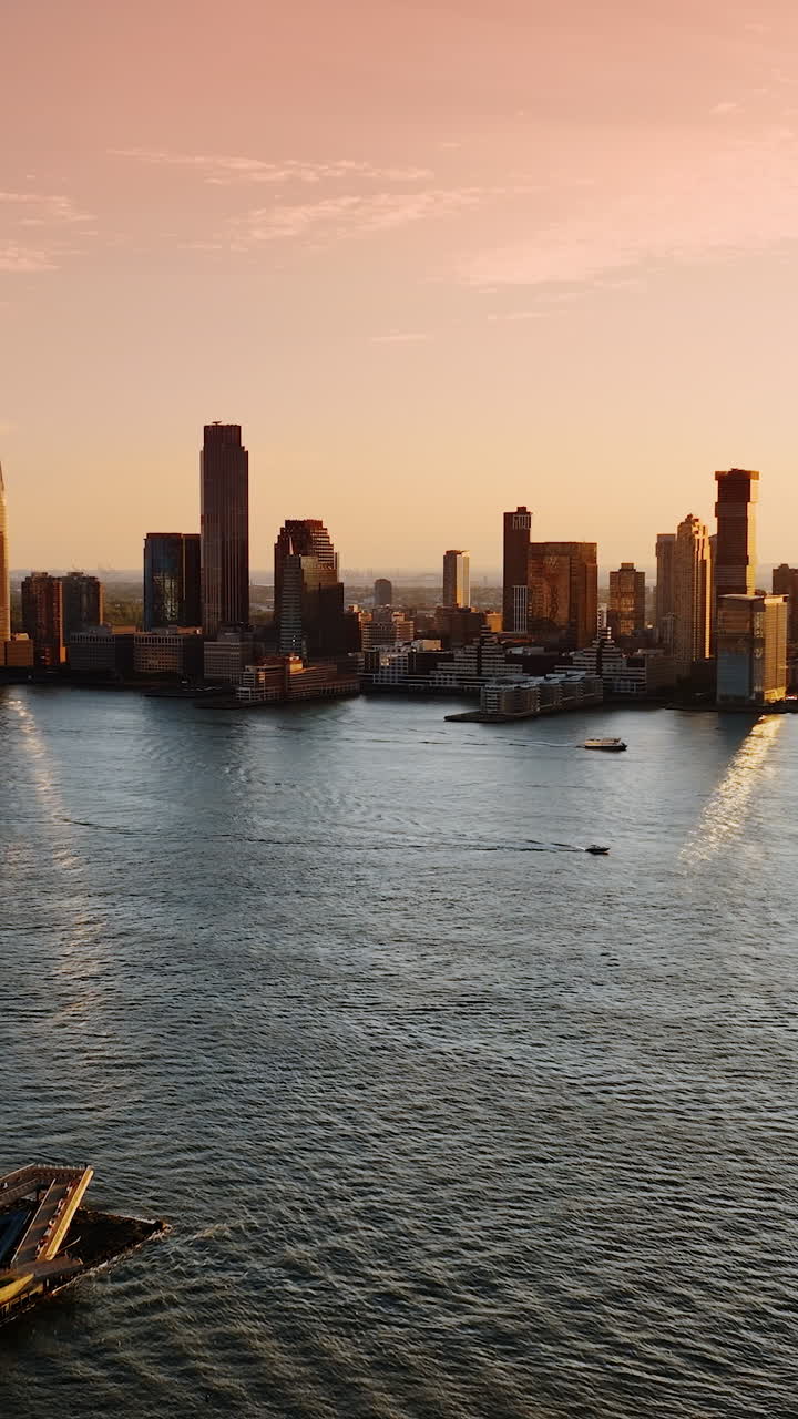 View of Hudson River on the Battery Park City. Boats and yachts on the water. Sight of New York luxurious skyscrapers from top. Vertical video