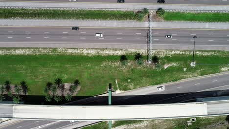 una vista aérea de arriba hacia abajo del tráfico a medida que avanza en los intercambios y autopistas en el centro de florida