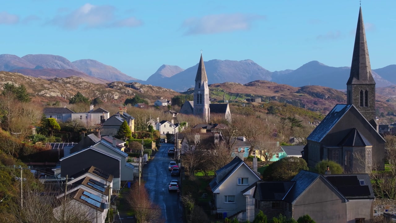 4K Aerial drone footage of St Joseph’s Church and Christ Church Clifden with Connemara Mountains Background_015