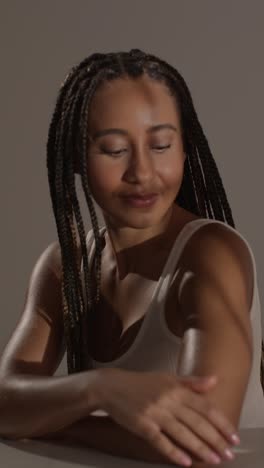 studio portrait shot of young woman feeling softness of skin after using beauty product 2