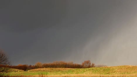 a storm passing by taking various elements of bad weather to the lands below