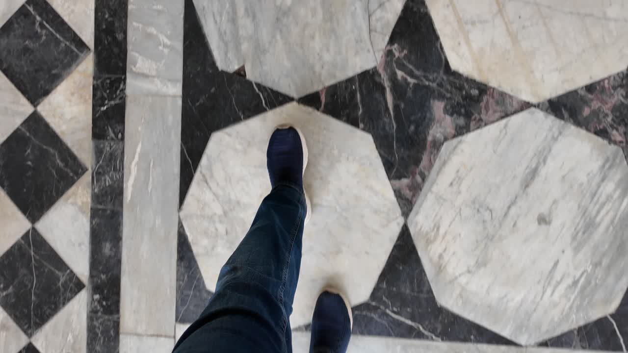 Person Walking on a Beautifully Patterned Marble Floor
