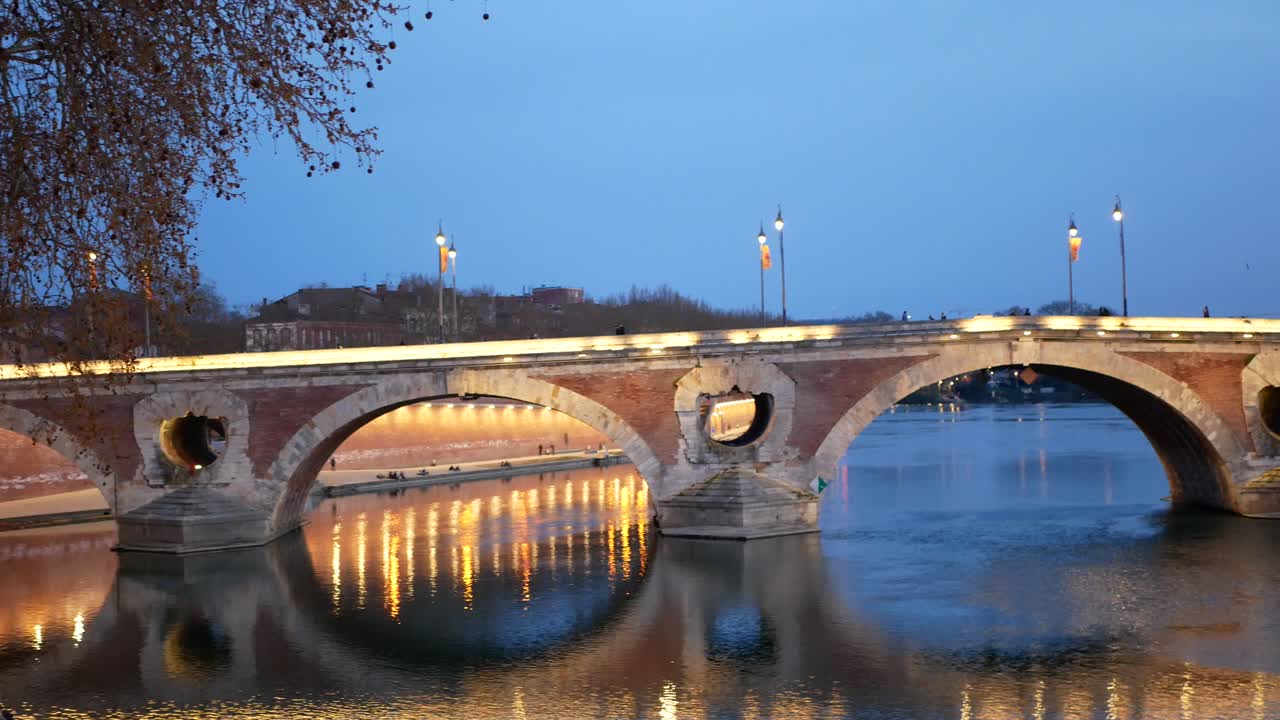 Panning view of the Pont Neuf bridge at sunset. Toulouse, France.