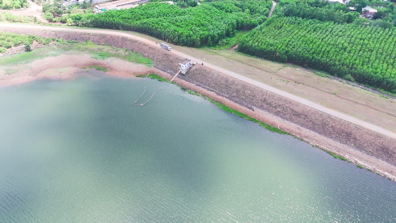 Aerial View of a Truck Driving on the Dam in Dong Nai.