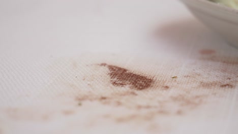 spilled food on a white tablecloth