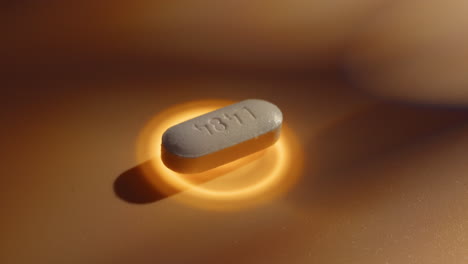 close-up of a white pill with l484 imprint