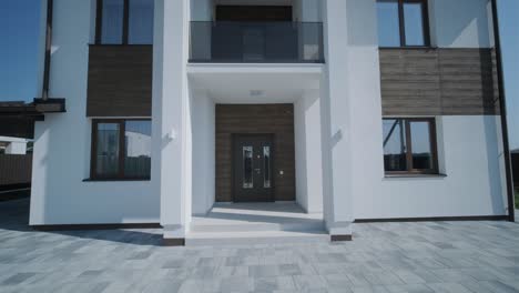 modern two-story house with paved driveway