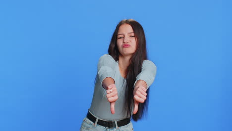 upset attractive young woman girl showing thumbs down sign gesture disapproval dissatisfied dislike