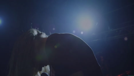 female singer swinging hair on concert stage, with animated sound waves boosting music marketing