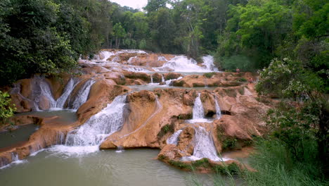 toma rotatoria de drones de las cascadas de agua azul y las cascadas con el bosque que rodea el río xanil en chiapas mexico