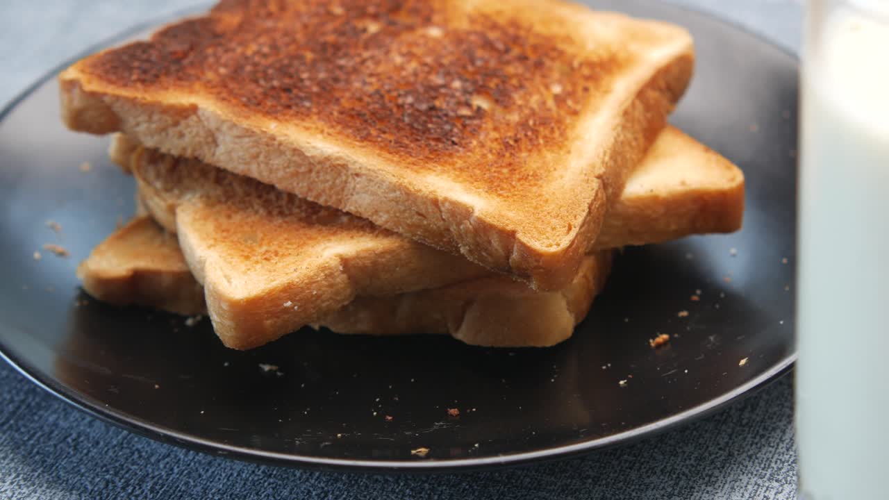 Close up of glass of milk and spoon on table