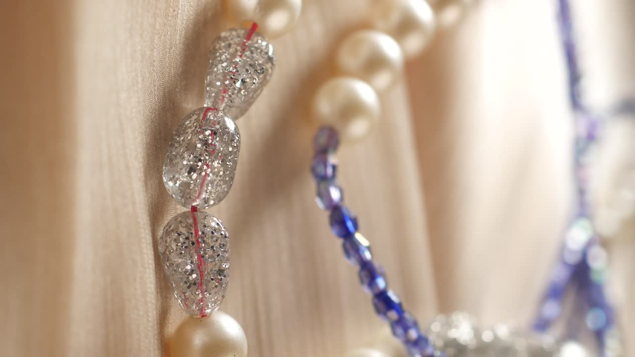 Close-up of a multi-strand necklace with pearls and crystals
