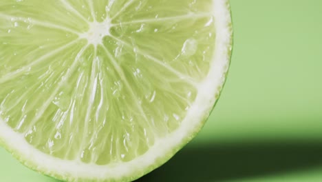 video of sliced lime with copy space over green background