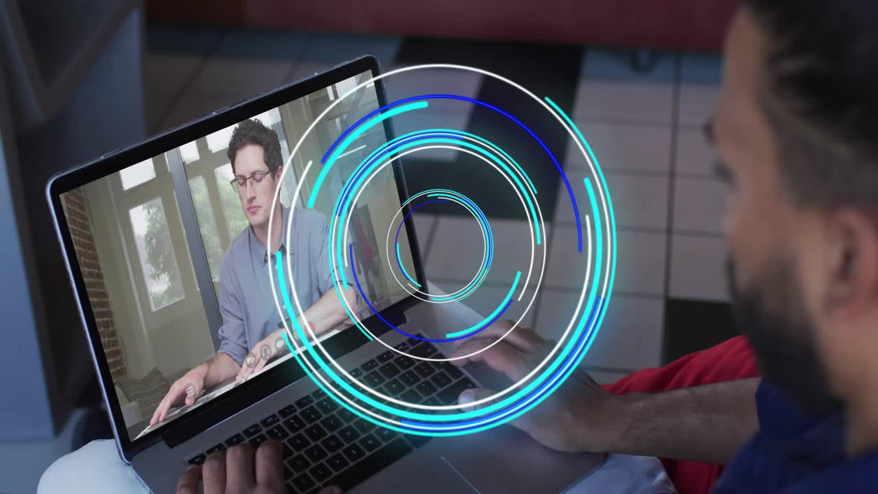 HUD appearing viewer watching laptop, host gesturing while rings centering trackpad for tech demo