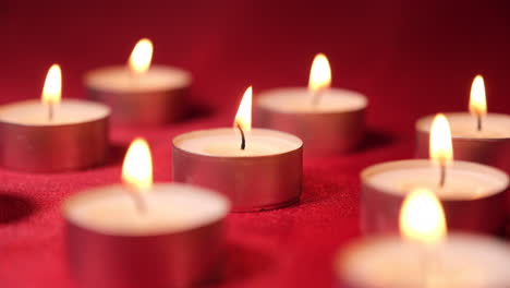 Candles-tea-lights-in-red-background