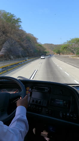 dashcam footage from a bus driver driving through a mountainous area as he changes lanes