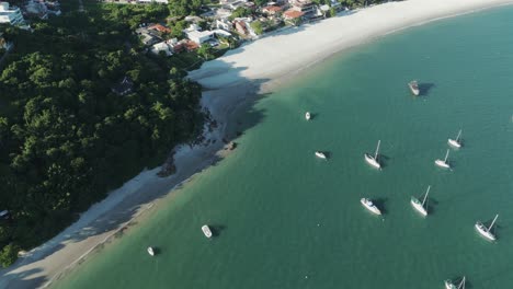 Aerial-view-of-boats-anchored-at-Jurere-Beach-in-Florianopolis,-Brazil