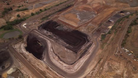 Black-coal-mine-open-cut-aerial-circling,-scorch-earth