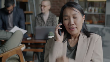 Businesswoman on Phone in Cafe