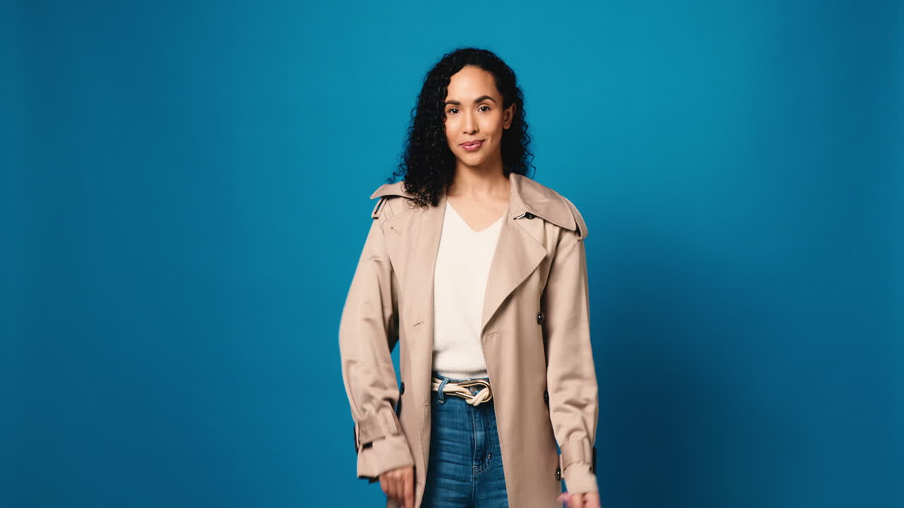 Woman in trench coat pointing