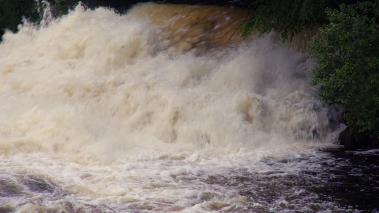 mid shot of Water entering the river Leven from Kinlochleven hydroelectric power station