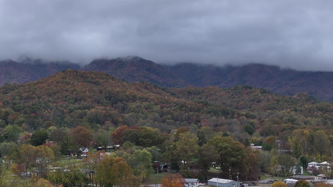 Aerial view of colorful trees, mountains, low clouds in North Carolina