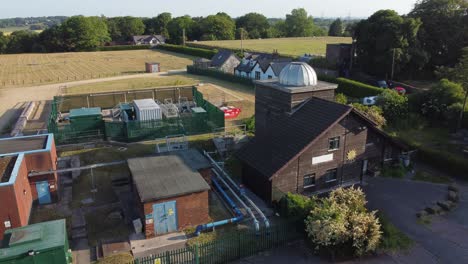 aerial view pex hill leighton observatory silver dome rooftop on hilltop farmland at sunrise, slow push in