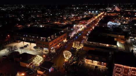 Slow-tracking-wide-arial-drone-shot-flying-high-over-Denver-Christmas-parade