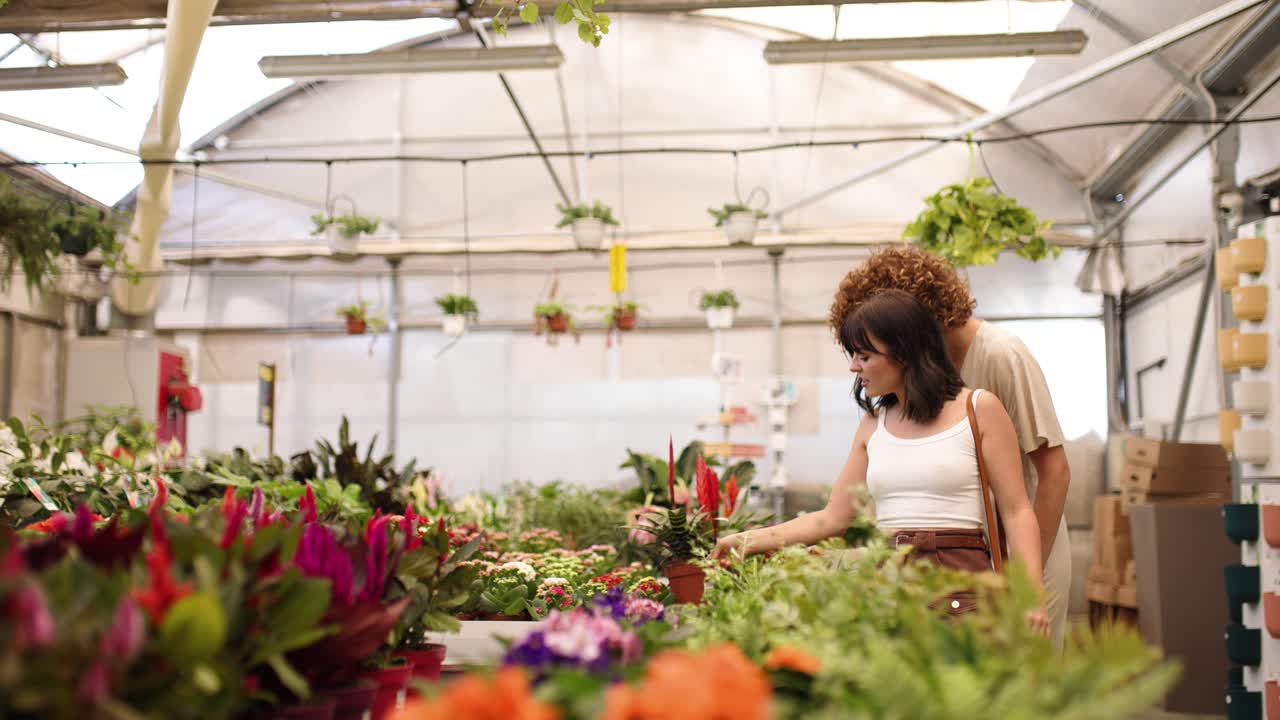 Customers choosing plants in garden center