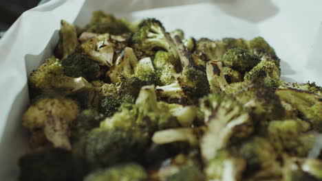 cooked broccoli steaming on pan