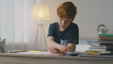 boy drawing at desk