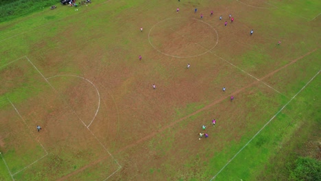 bird's eye view of a football field with men playing with the ball at trindade,são tomé,africa