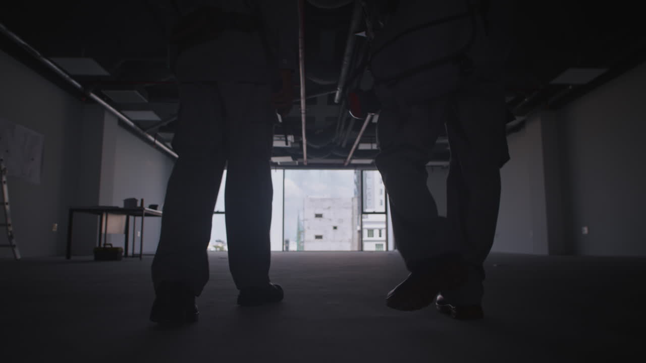 Construction Workers Examining How to Provide Space with Electricity