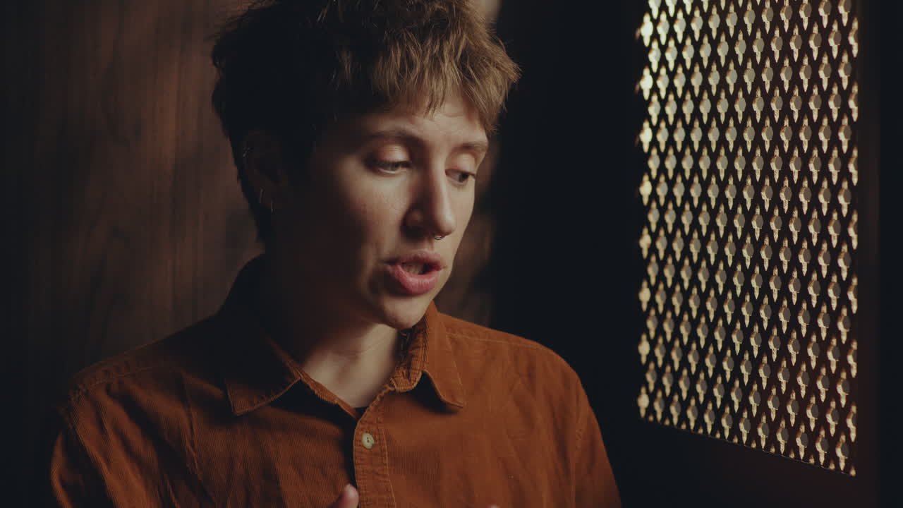 Young Female Penitent Talking in Confessional Stall